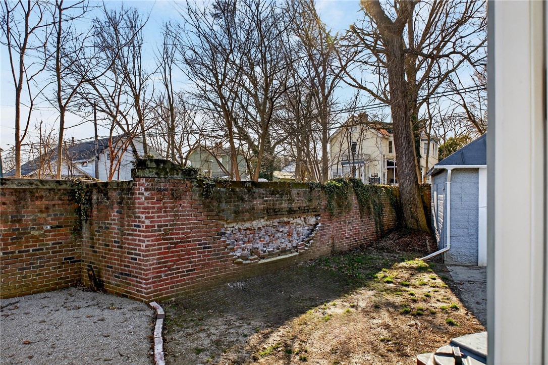107 Riverside Drive Piqua, OH 45356 - Photo 49 of 69 This property features a private yard with a brick fence and a storage shed.