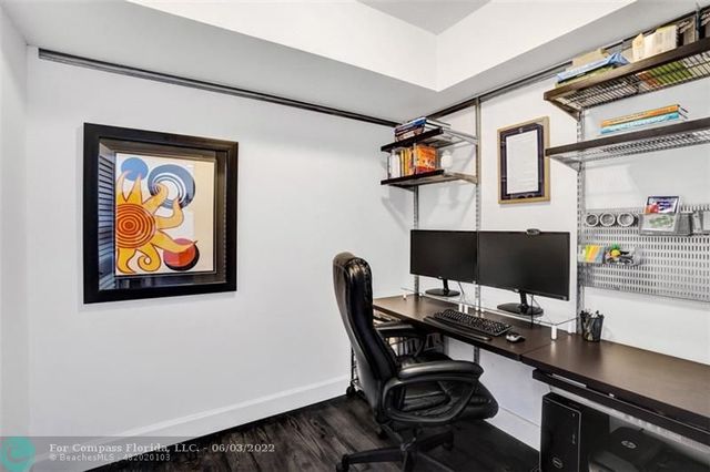 a view of a workspace with furniture and wooden floor