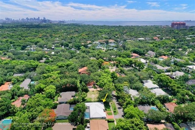 an aerial view of a house with yard and outdoor seating