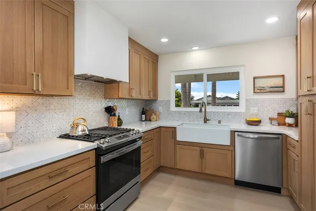 a kitchen with stainless steel appliances granite countertop a sink stove and cabinets