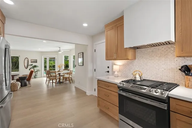 a kitchen with a stove and white cabinets