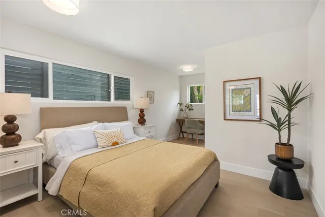 a bedroom with a bed and large flat screen tv