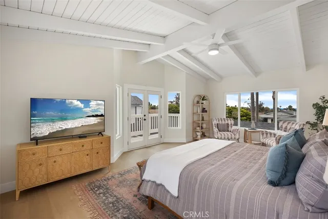 a bedroom with a bed a couch and a large window