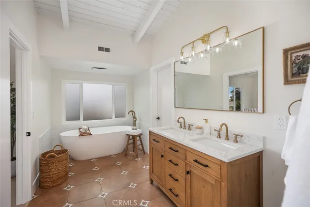 a bathroom with a sink double vanity and a mirror