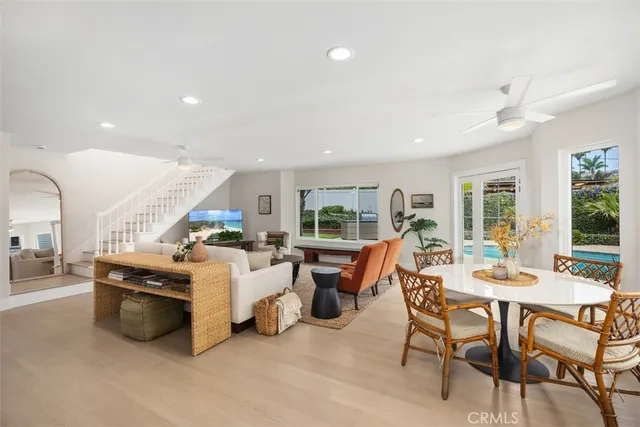 a living room with furniture a large window and a table