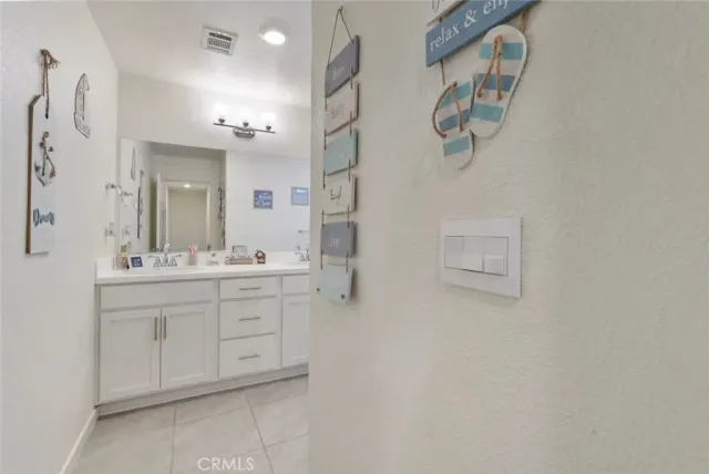 a bathroom with a double vanity sink mirror and