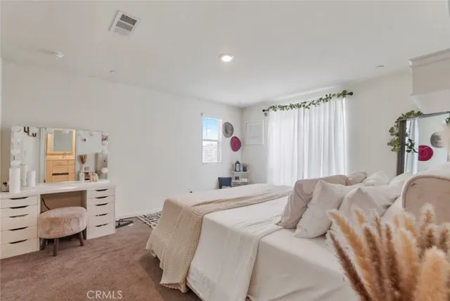 a bedroom with a bed and a couch