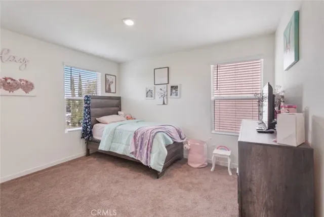 a spacious bedroom with a bed and a window