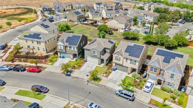 an aerial view of residential house with outdoor space and seating area