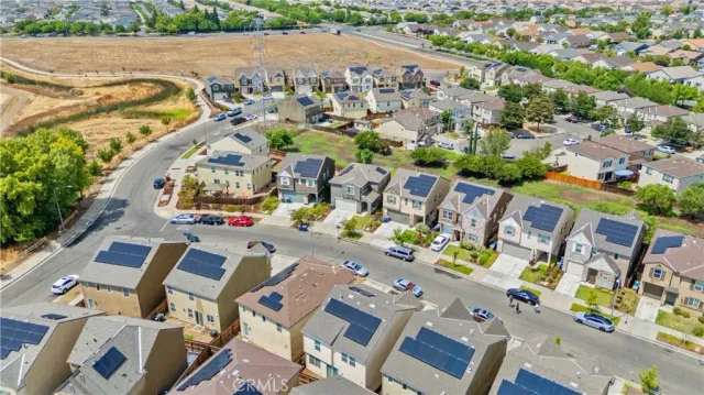 an aerial view of a swimming pool with outdoor seating and city view