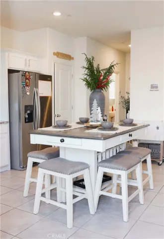 a kitchen with granite countertop a table and chairs in it