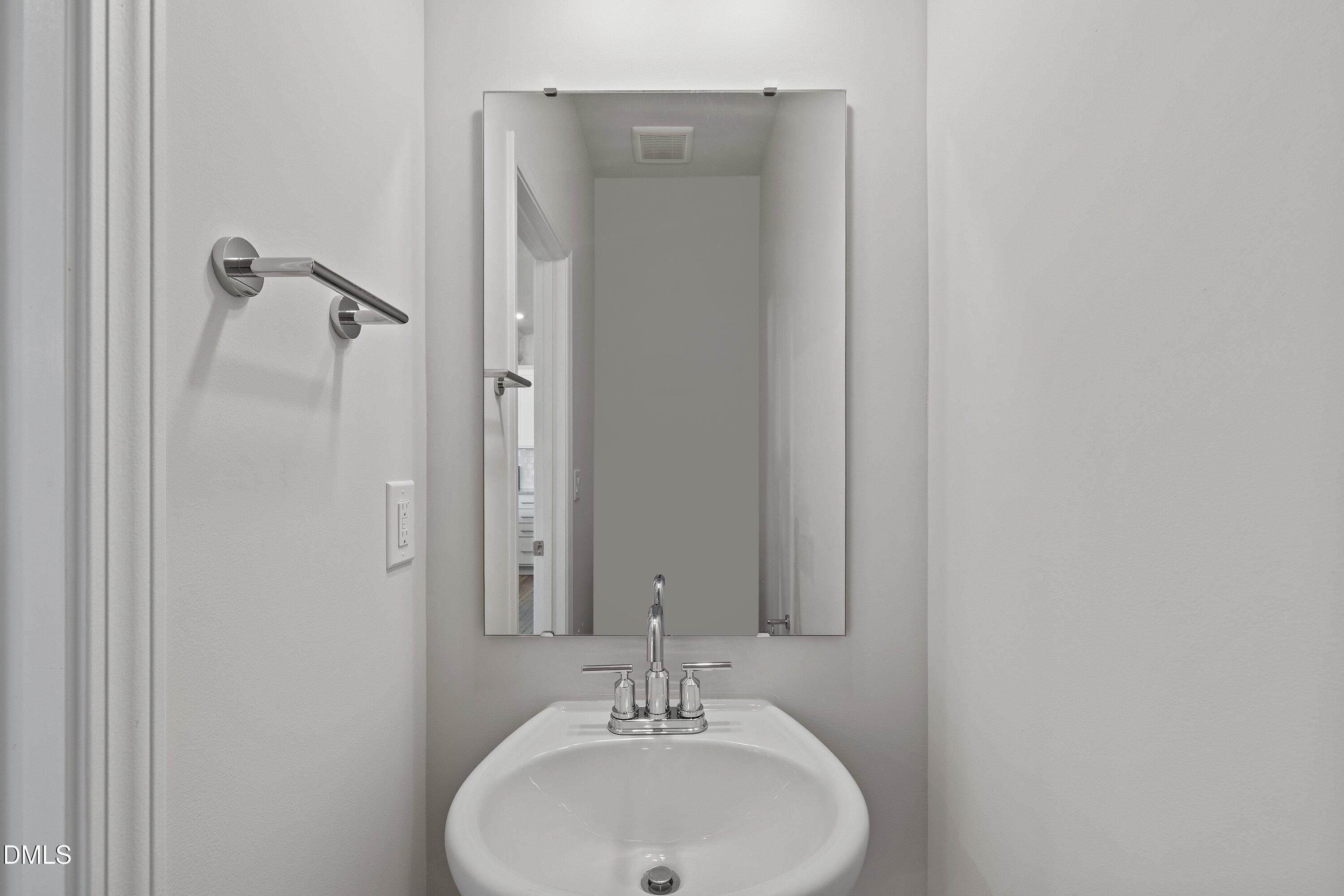 7242 Morris Acres Road Apex, NC 27523 - Photo 13 of 35 a bathroom with a sink and a mirror