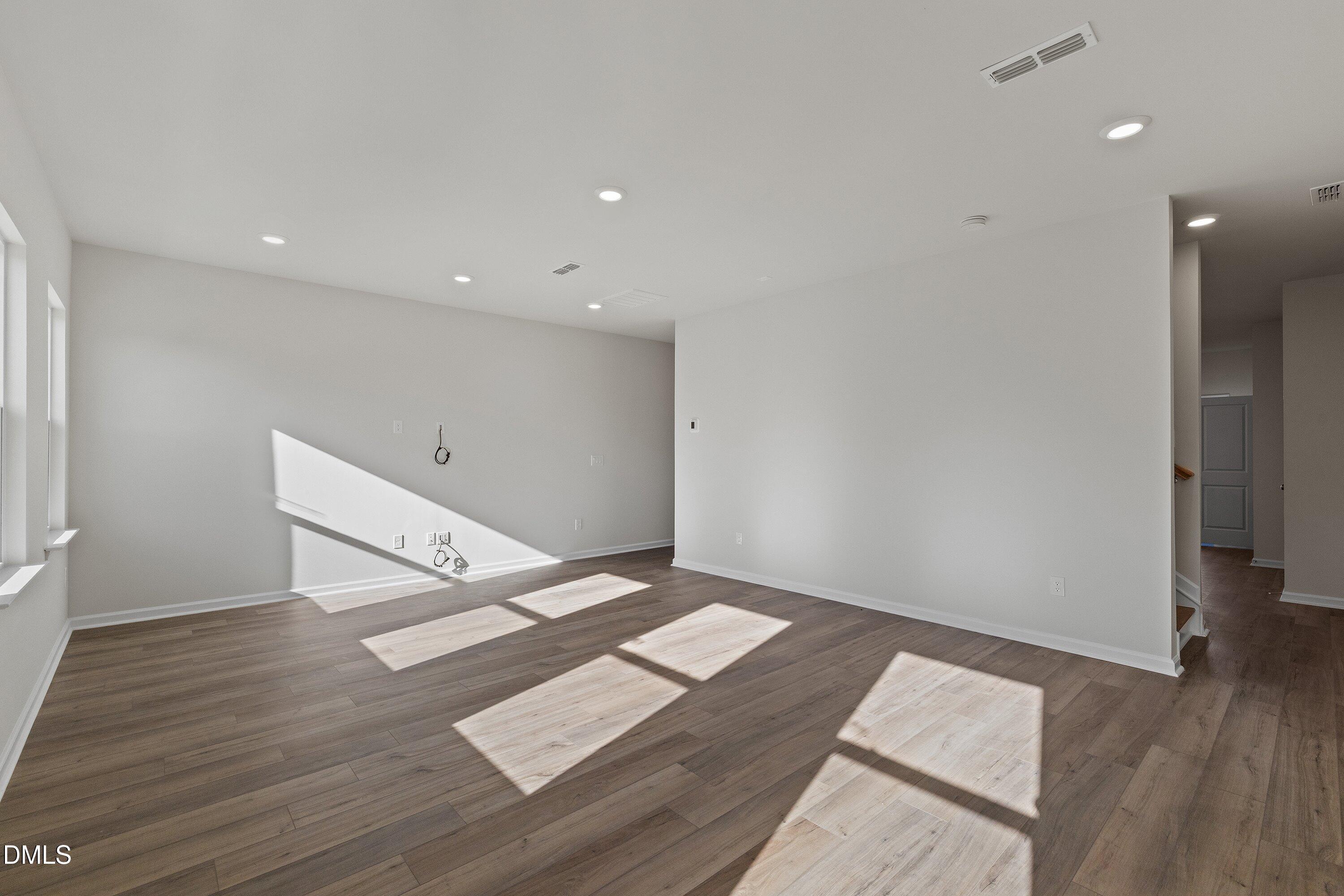 7242 Morris Acres Road Apex, NC 27523 - Photo 15 of 35 a view of an empty room with wooden floor