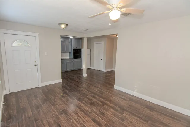 wooden floor in an empty room with a window