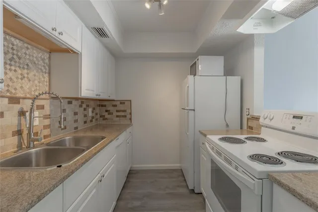 a kitchen with a sink and a refrigerator
