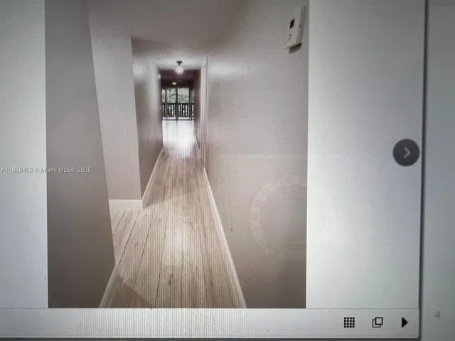 a view of a hallway view with wooden floor and staircase