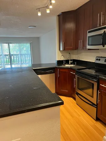 a kitchen with a sink and a microwave
