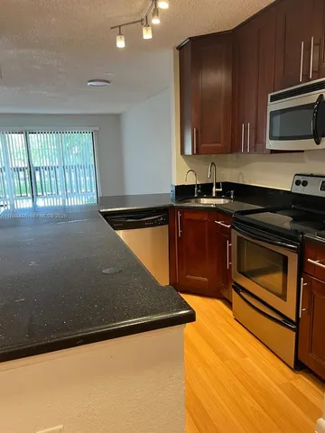 a kitchen with a sink and a microwave