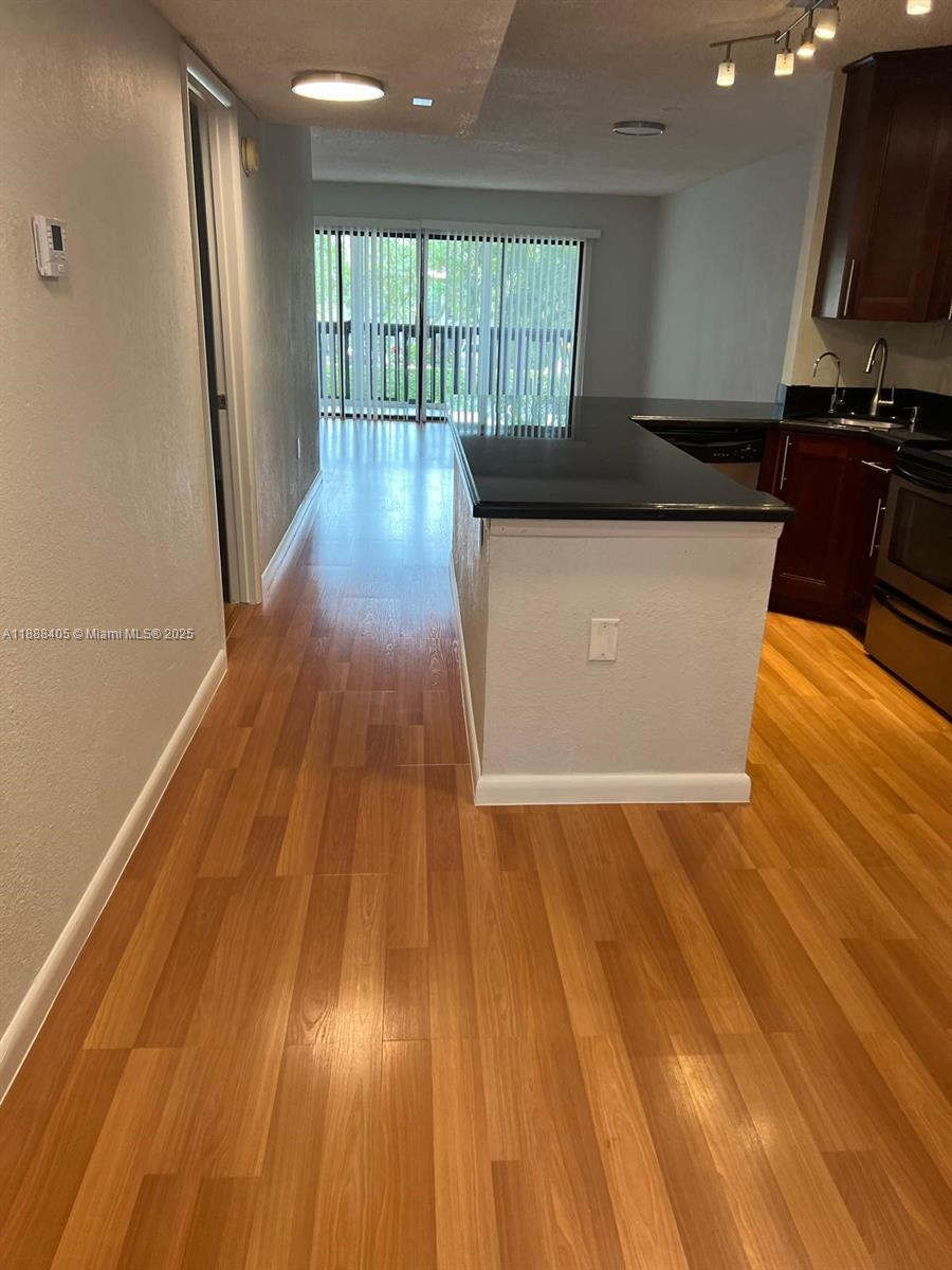 1021 Mockingbird Lane, Unit 209 Plantation, FL 33324 - Photo 17 of 26 a view of a kitchen with wooden floor and a sink