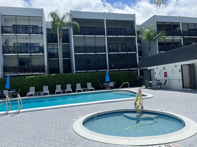 a swimming pool with outdoor seating