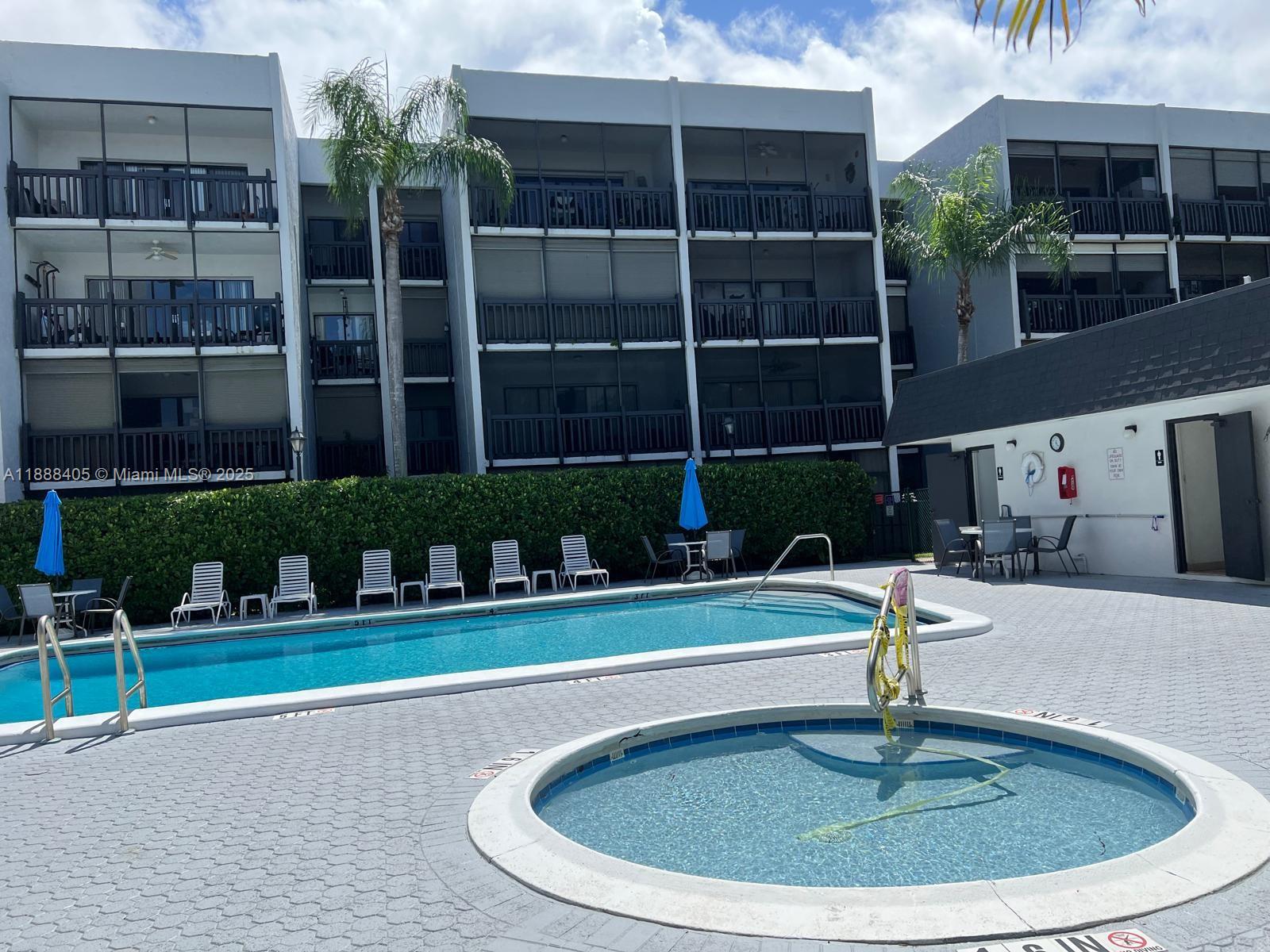 1021 Mockingbird Lane, Unit 209 Plantation, FL 33324 - Photo 22 of 26 a swimming pool with outdoor seating