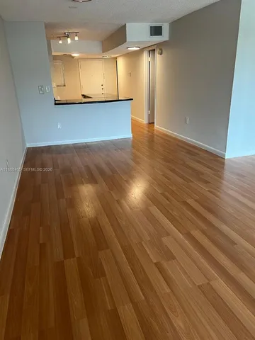 a view of a room with wooden floor