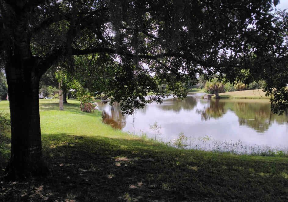 6113 Spring Garden Place Fort Pierce, FL 34951 - Photo 3 of 6 a view of a lake from a yard