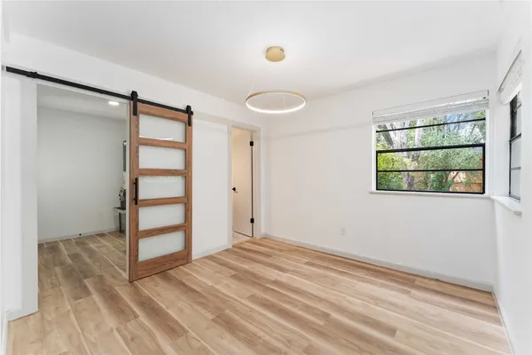 an empty room with windows and closet