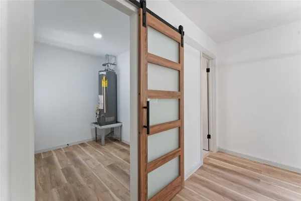 a view of entryway and hall with wooden floor