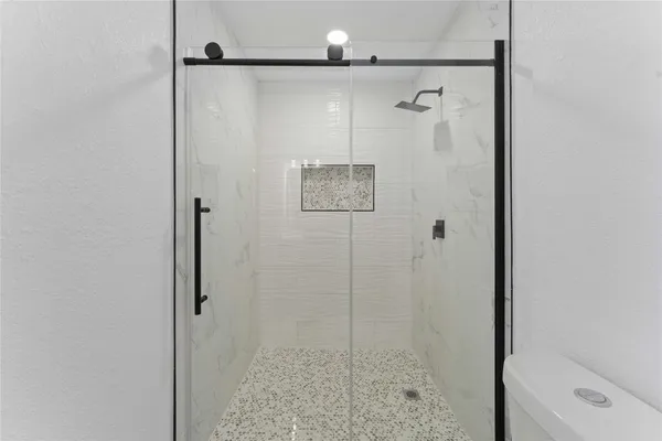 a bathroom with a shower and a mirror