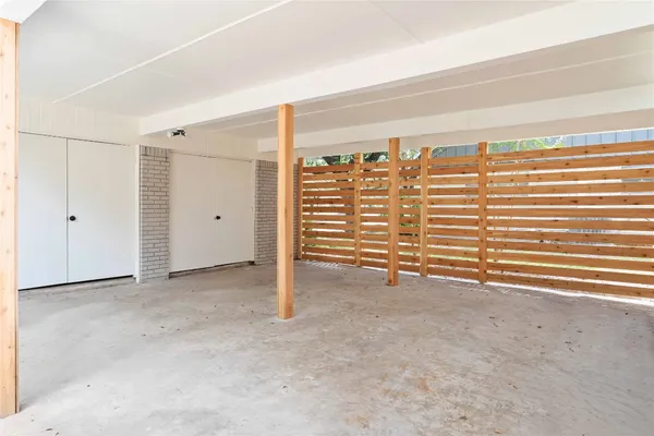 an empty room with a exposed radiator and stairs