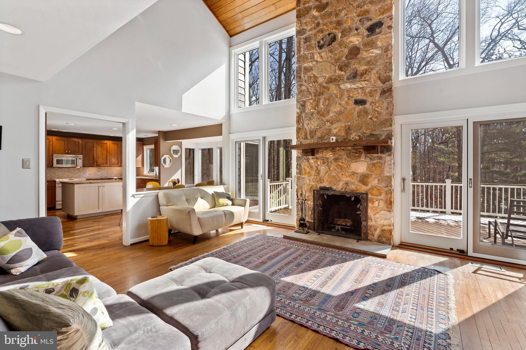 1053 Beaumont Road Berwyn, PA 19312 - Photo 16 of 63 Fireplace is flanked by windows & 2 sliding doors.