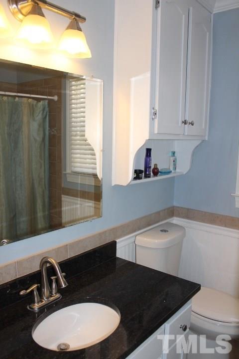 2205 Millpine Drive Raleigh, NC 27614 - Photo 17 of 22 Hall bath was updated with granite counter tops, ceramic floor tiles and tiles surrounding the tub.