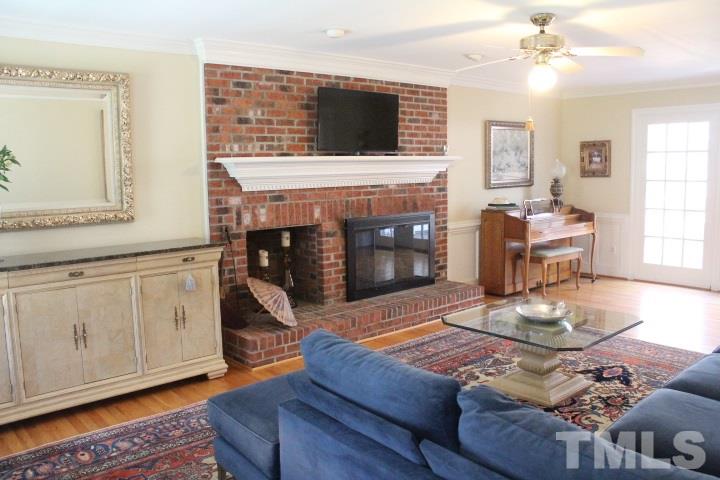 2205 Millpine Drive Raleigh, NC 27614 - Photo 5 of 22 25'x14' Front to Back Family Room has hardwood floors. Masonry Wood Burning fireplace with firewood box. Crown moldings, chair-rails and wainscoting.