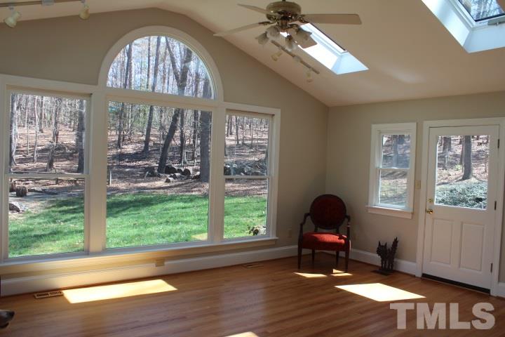 2205 Millpine Drive Raleigh, NC 27614 - Photo 7 of 22 19'14.5' Sunroom with hardwood floors overlooks private backyard.