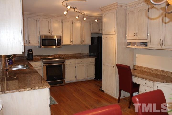 2205 Millpine Drive Raleigh, NC 27614 - Photo 8 of 22 Kitchen has been updated with Stainless Steel finish appliances, granite counter tops. It also has a built-in desk.