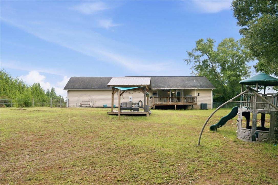 520 Sharon Lane Seneca, SC 29678 - Photo 34 of 48 A spacious backyard with a private deck and covered patio for outdoor enjoyment.