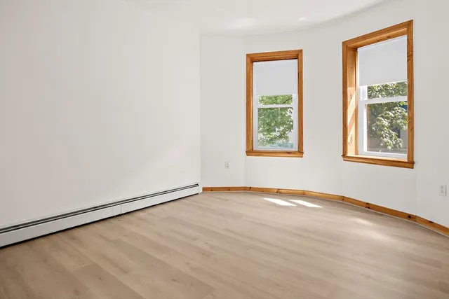 a view of a room with wooden floor and a cabinet