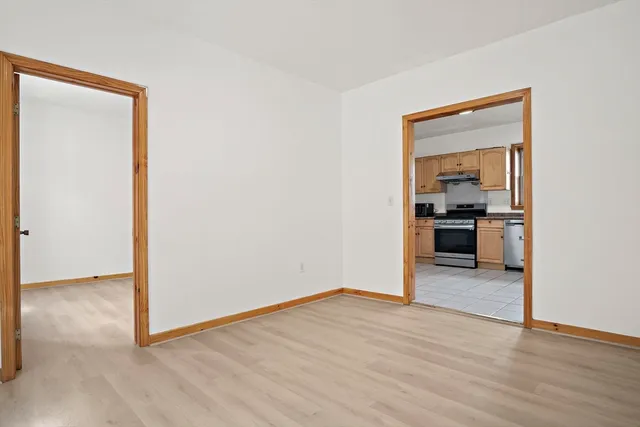 a view of a room with wooden floor and a window