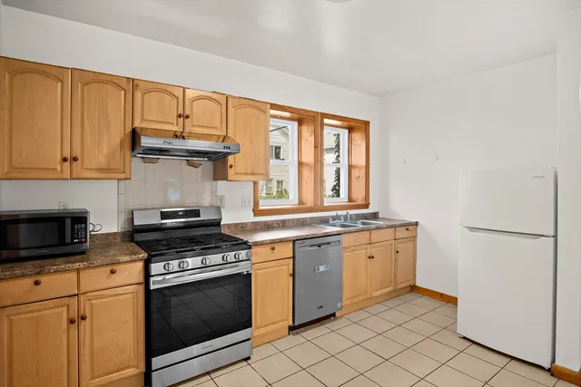 a kitchen with a refrigerator and a stove
