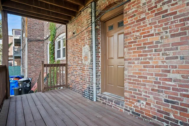 a view of a balcony with wooden floor
