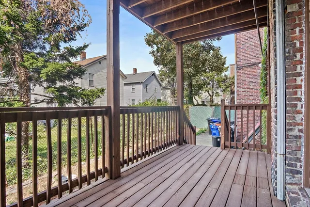 a view of a cars park in front of a building