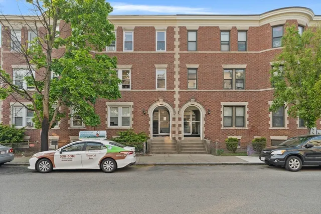 a view of a car parked in front of a house