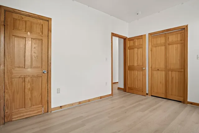 an empty room with wooden floor