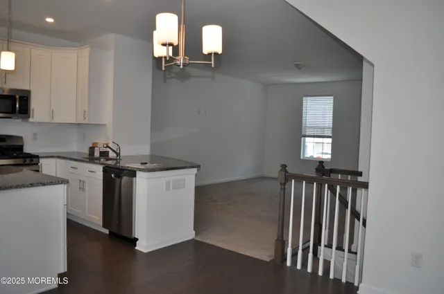 a kitchen with a refrigerator and window