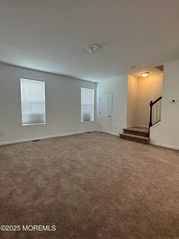 an empty room with a empty space and windows