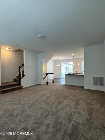 a view of an empty room and a window