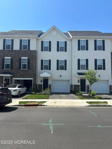 a view of the house with swimming pool and a yard