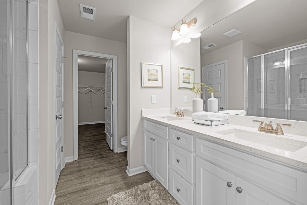7 Purackal Lane Statham, GA 30666 - Photo 31 of 57 a bathroom with a double vanity sink and a mirror