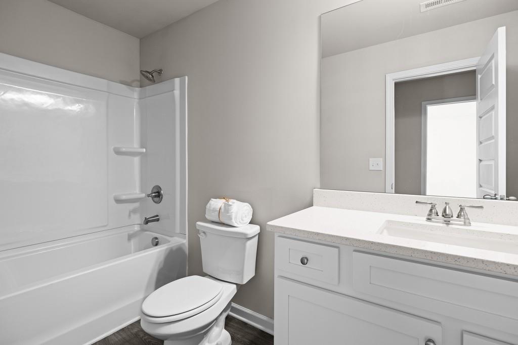 7 Purackal Lane Statham, GA 30666 - Photo 37 of 57 a bathroom with a sink a toilet and a bathtub
